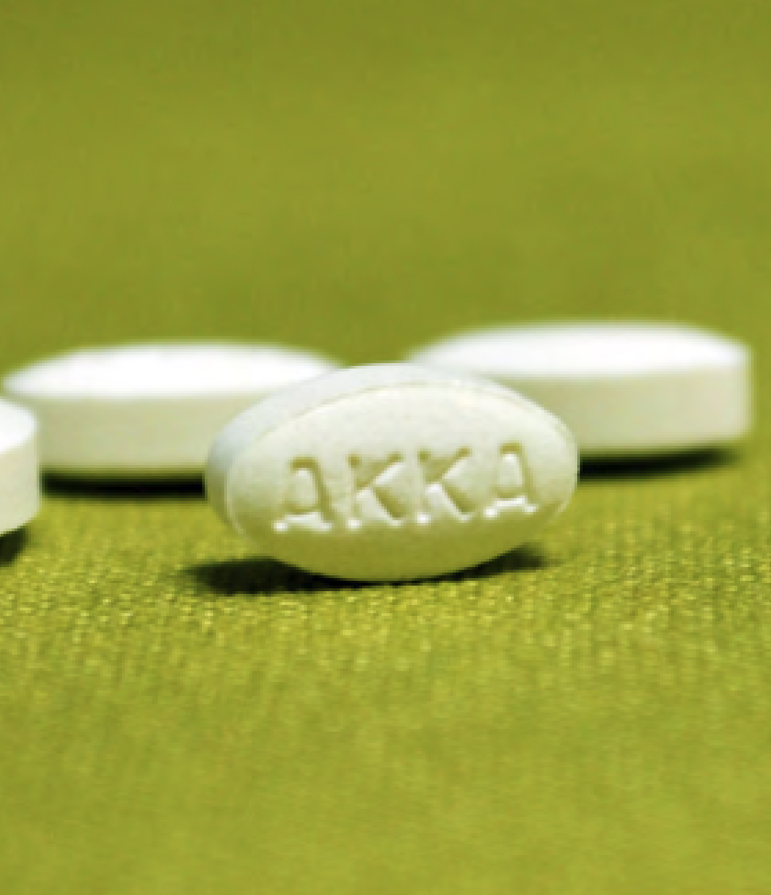 White pills on a green background